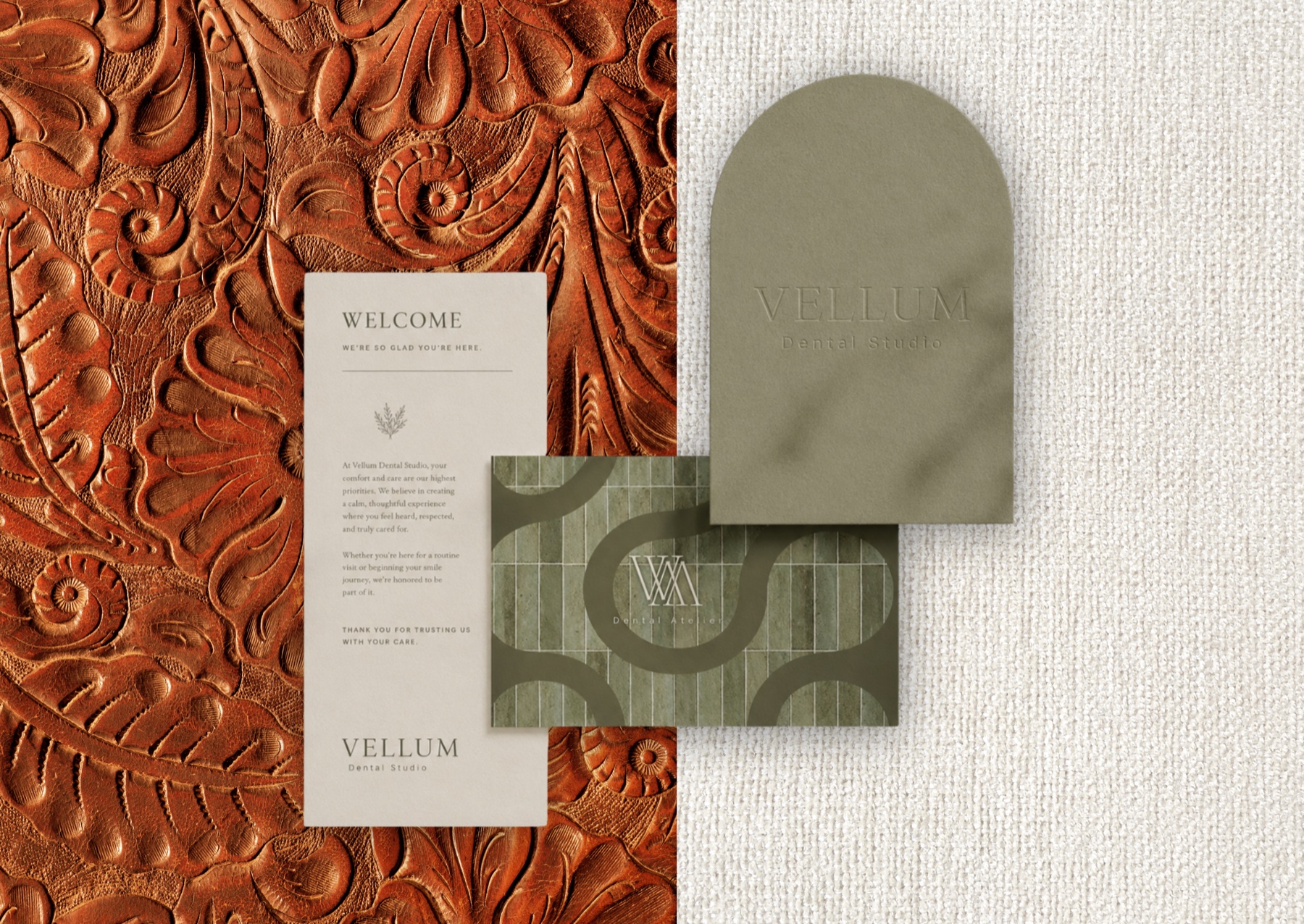 Vellum welcome card and stationery flat-lay on tooled leather